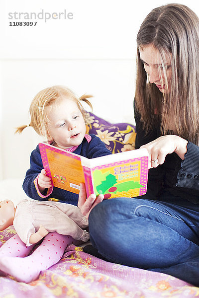 Mutter und Tochter lesen gemeinsam ein Buch