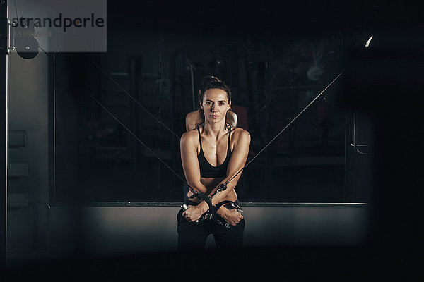 Porträt einer selbstbewussten Frau beim Training im Fitnessstudio