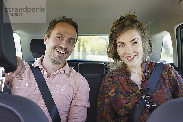 Porträt des glücklichen Paares im Auto sitzend