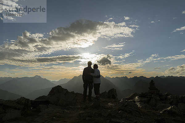 Glückliches Paar bei Sonnenuntergang in den Bergen