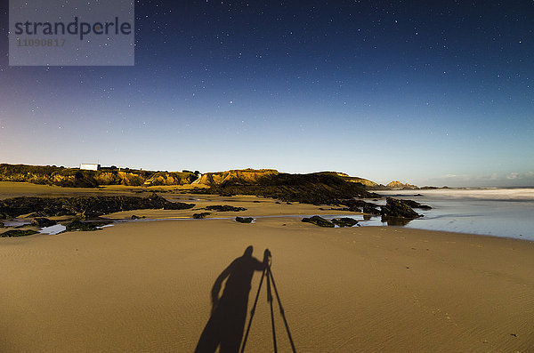 Spanien  Galizien  Ferrol  Schatten eines Fotografen auf Playa de Ponzos bei Nacht