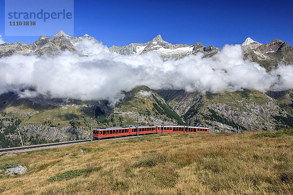 Die Bahn auf ihrer Strecke mit hohen Gipfeln und Bergkette im Hintergrund  Gornergrat  Kanton Wallis  Schweizer Alpen  Schweiz  Europa