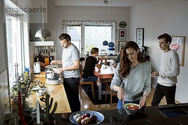 Familie bei der Zubereitung von Speisen in der Küche