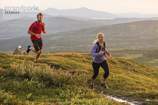 Ehepaar joggt in den Bergen