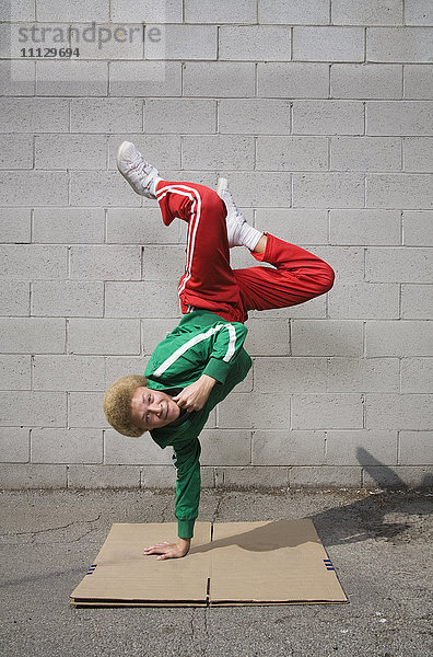 Gemischtrassiger Junge beim Breakdance