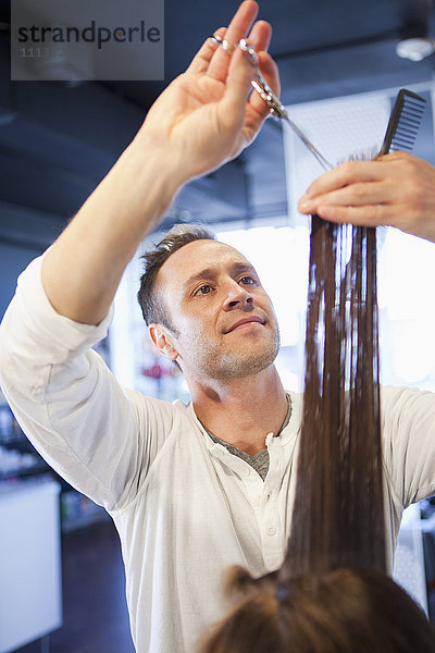 Friseurin schneidet Haare im Salon