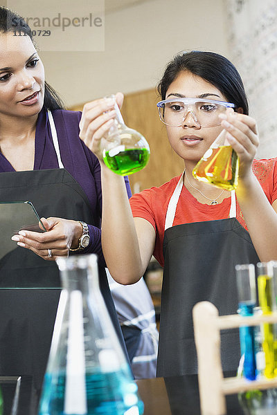 Lehrer und Schüler arbeiten mit Chemikalien im Klassenzimmer