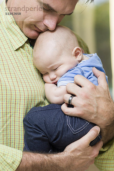 Kaukasischer Vater hält kleinen Jungen