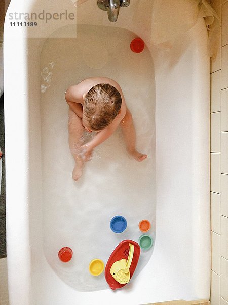 Junge spielt mit Spielzeug in der Badewanne