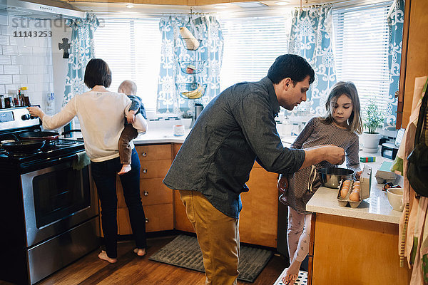 Eltern kochen mit Kindern in der Küche