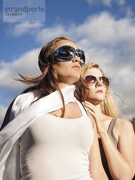 Kaukasische Frauen mit Sonnenbrille und Blick nach oben