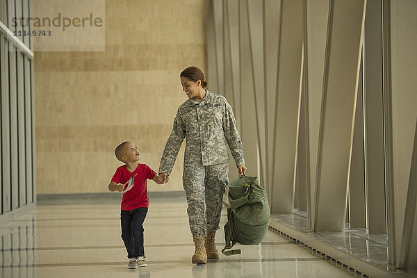 Afroamerikanischer Soldat und Sohn auf dem Flughafen