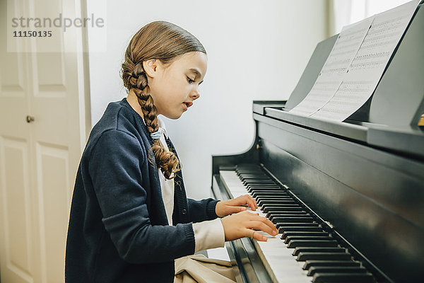 Gemischtrassiges Mädchen spielt Klavier