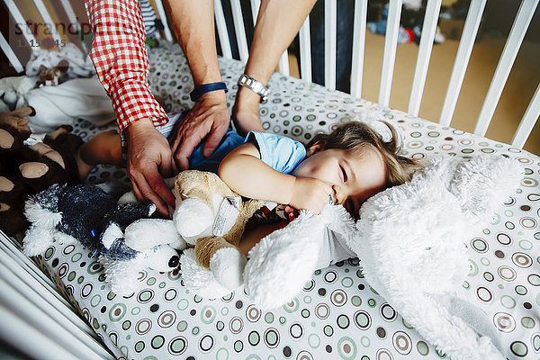 Schwule Väter kitzeln ihren kleinen Sohn im Kinderbett