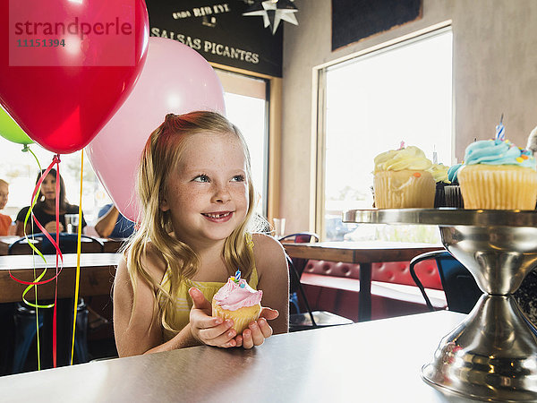 Kaukasisches Mädchen feiert Geburtstag in einem Cafe