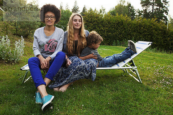 Teenager und Junge entspannen sich auf einem Liegestuhl