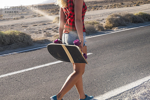 Spanien  Teneriffa  blonde junge Skaterin mit Skateboard