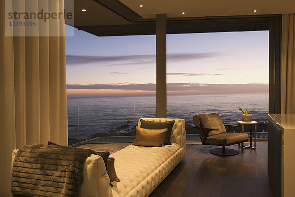 Twilight ocean view beyond luxury home showcase interior