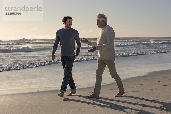 Glücklicher Vater und Sohn beim Spaziergang am Strand