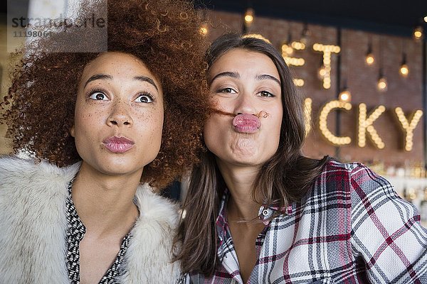 Porträt von glücklichen Freundinnen  die Spaß im Cafe haben