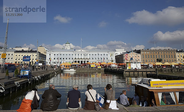 Touristen und Fähre auf der Hafenseite von Helsinkis historischem Hafenviertel