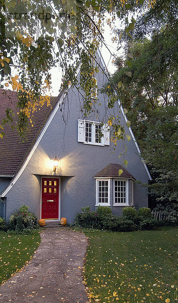 Außen graues Haus im Landhausstil mit Spitzdach und roter Tür in Chico