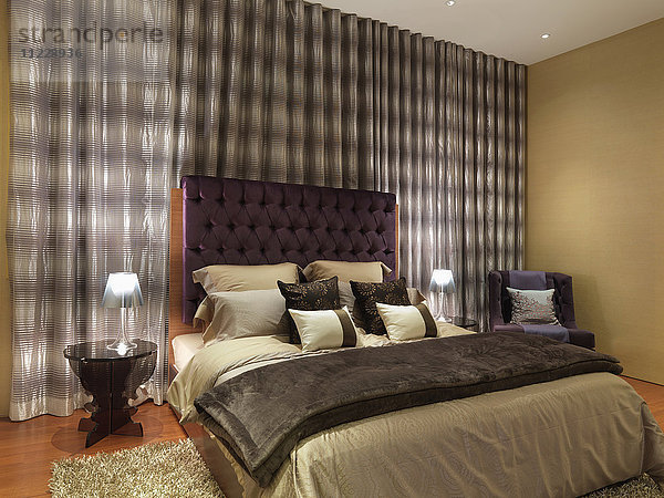 Elegantes modernes Schlafzimmer mit lila Samtkopfteil