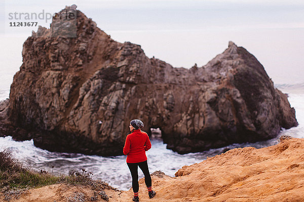 Wanderer genießt Aussicht am Strand  Big Sur  Kalifornien  USA