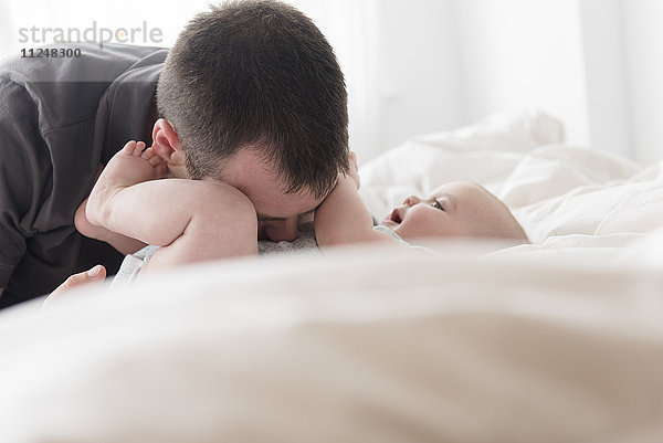 Vater küsst Baby Tochter (12-13 Monate) Bauch