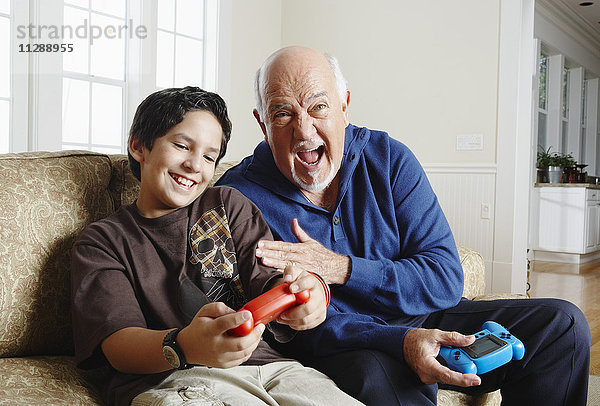 Großvater und Enkel spielen Videospiele