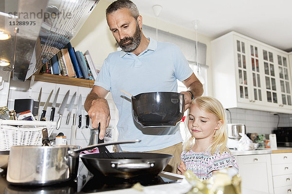 Mädchen kocht mit Vater