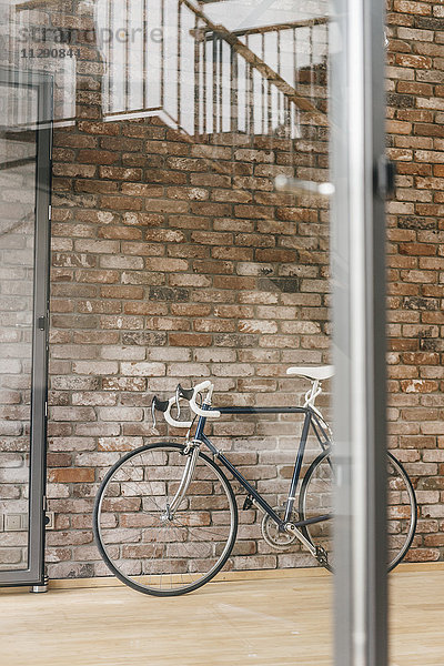 Fahrrad an der Ziegelwand im Büro