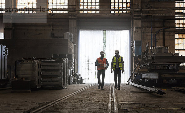Stahlarbeiter  die in der Fabrik spazieren gehen