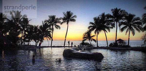 Sonaisali  Fidschi  Südpazifik  Sonnenuntergang  Swimmingpool  Gegenlicht  Palmen  Romantisch  Stimmung  Hotelpool  Personen  Springbrunnen