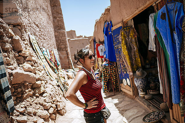 Marokko  Ouarzazate  Touristen stehen vor dem Bekleidungsgeschäft