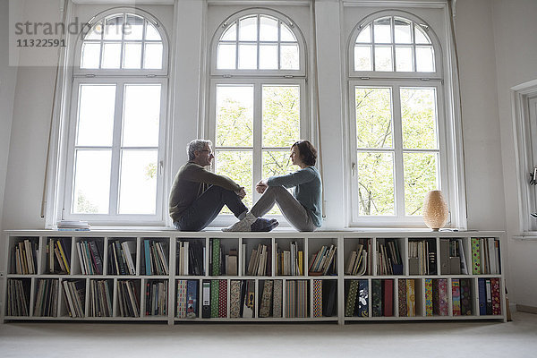 Erwachsenes Paar am Fenster sitzend