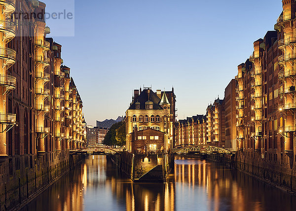 Deutschland  Hamburg  Speicherstadt  beleuchtete Altbauten mit Elbphilharmonie im Hintergrund