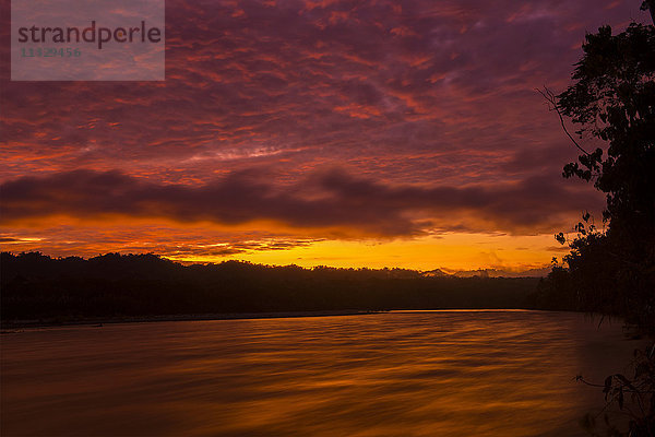 Sonnenuntergang über dem Fluss Madre de Dios im Manu-Nationalpark in Peru
