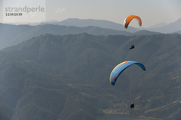 Gleitschirmflieger fliegen über Pokhara  Nepal  Himalaya  Asien