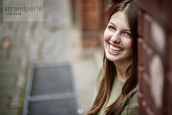 Portrait einer lächelnden jungen Frau im Freien