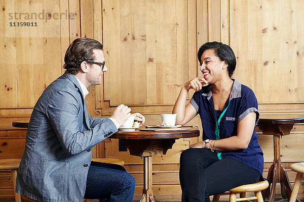 Mann und Frau sitzen im Café und trinken Kaffee