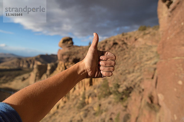 Felskletterer mit Daumen-hoch-Zeichen  Nahaufnahme  Smith Rock State Park  Oregon  USA