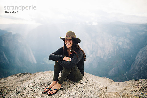 Porträt einer jungen Frau auf dem Gipfel eines Berges mit Blick auf den Yosemite-Nationalpark  Kalifornien  USA
