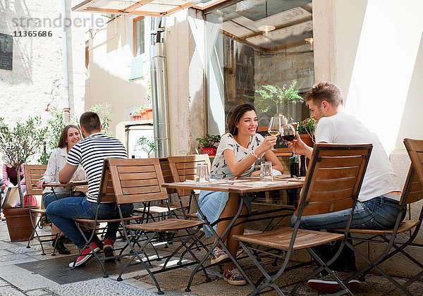 Junge Paare stoßen in einem Straßenrestaurant in Split  Dalmatien  Kroatien  auf den Wein an