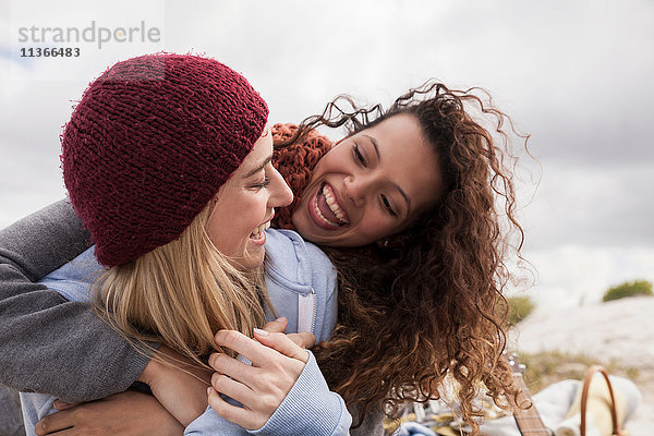 Zwei junge Freundinnen umarmen sich am Strand  Western Cape  Südafrika
