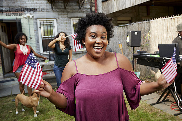 Frauen feiern mit amerikanischen Fahnen im Hinterhof