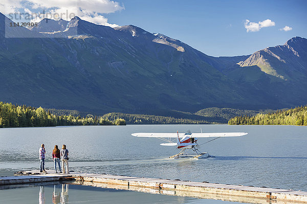 Besucher beobachten den Start eines Wasserflugzeugs  Trail Lake Float Plane Base  Moose Pass  Kenai Peninsula  Southcentral Alaska  USA