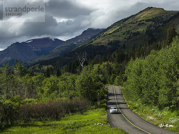 Ein Auto fährt entlang der Straße im Waterton Lakes National Park; Alberta  Kanada'.