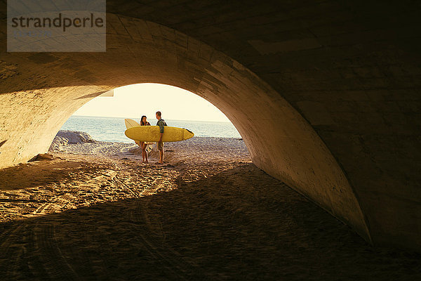 Surferpaar in der Unterführung von Newport Beach  Kalifornien  USA