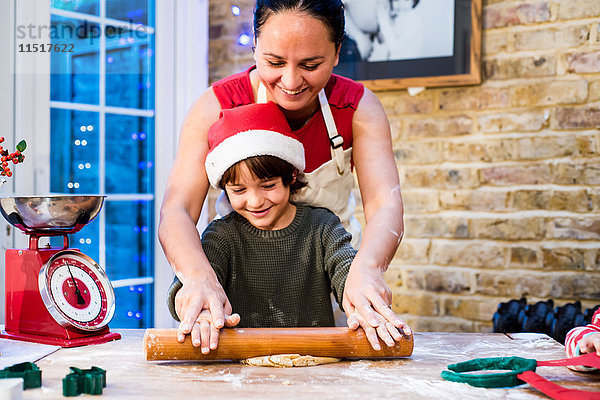 Mutter und Sohn backen zu Hause Weihnachtsplätzchen